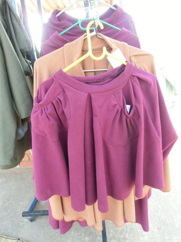 Maroon short skirt with front pockets and a matching poloneck body suit