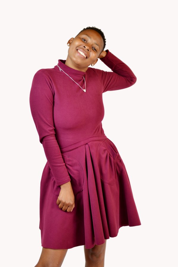 Maroon short skirt with front pockets and a matching polo neck body suit
